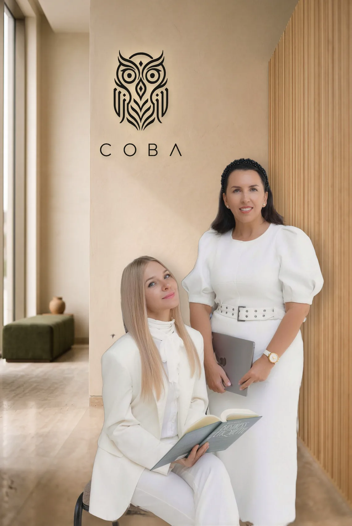 Hana Kash and Natalia Scully, co-founders of COBA, beside the owl mark on a plaster wall.