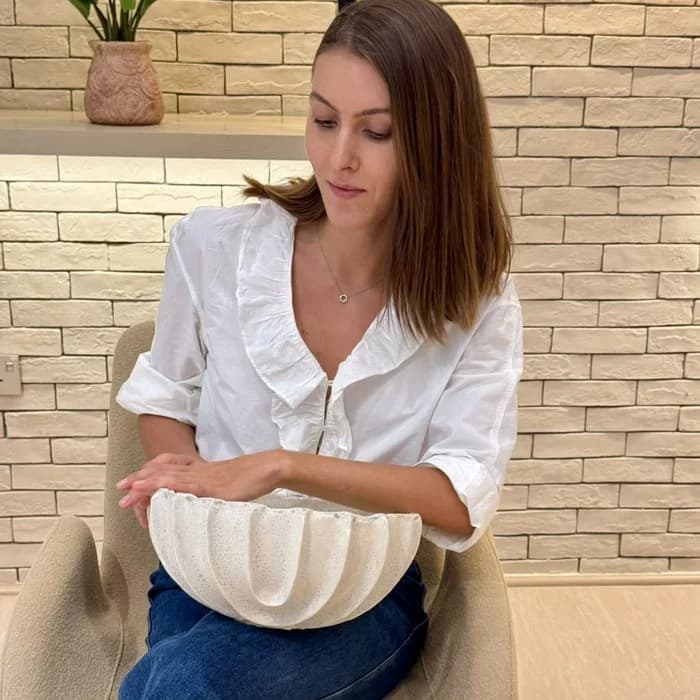 Irina Dyachenko holding a hand-built bowl